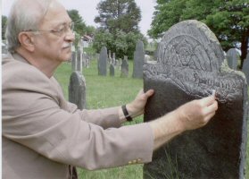 Rubbing chalk on a gravestone